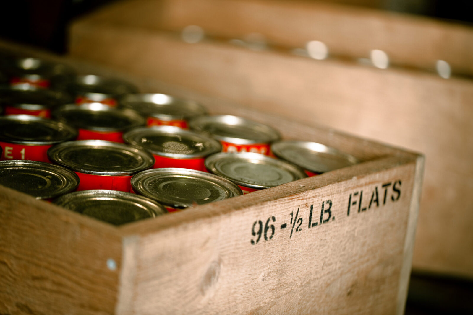 Close up of salmon cans in a cedar crate
