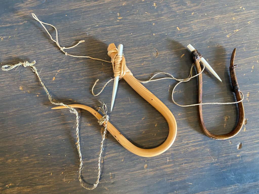 Two halibut fishing hooks made of wood and bone