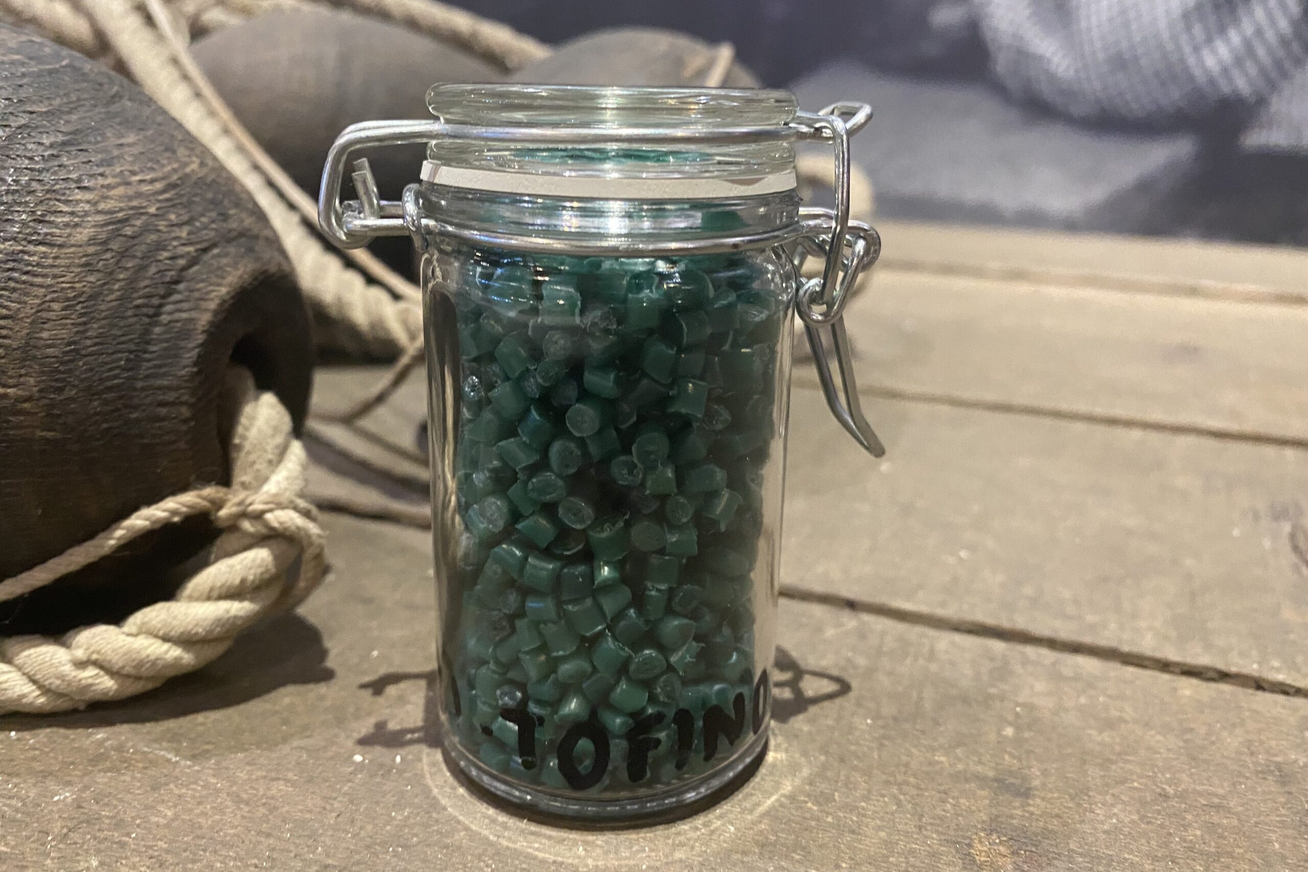 glass jar full of green pellets