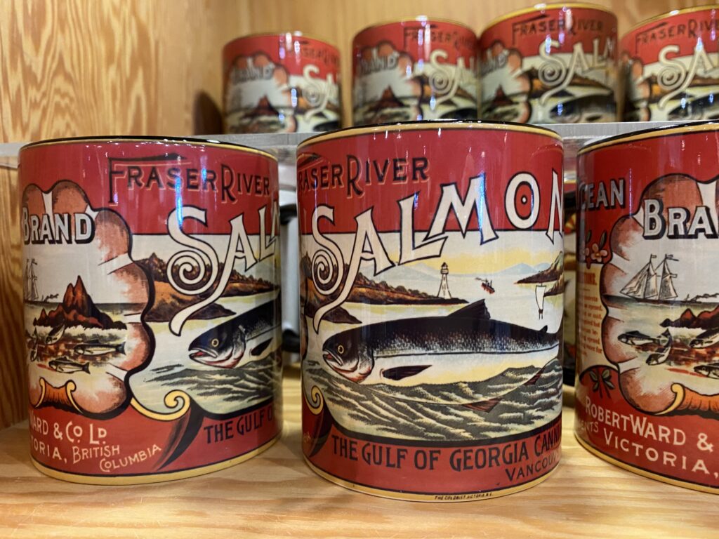 close up of red mugs with illustration of salmon and text that says Fraser Salmon